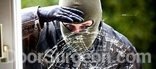 Burglar peeking in shattered glass window Acheson.