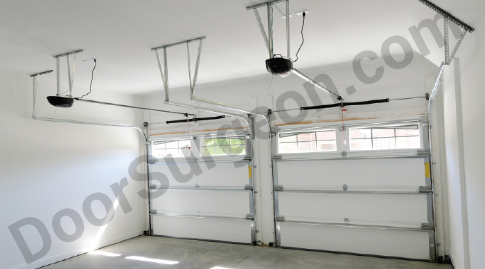 residential garage interior showing double garage doors with windows and springs