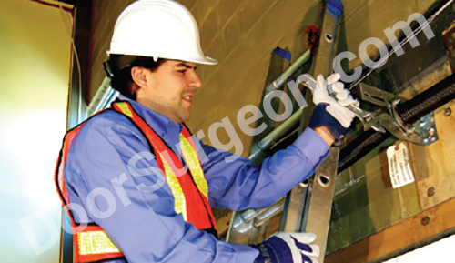Door Surgeon repair technician performing garage door adjustment and installation.
