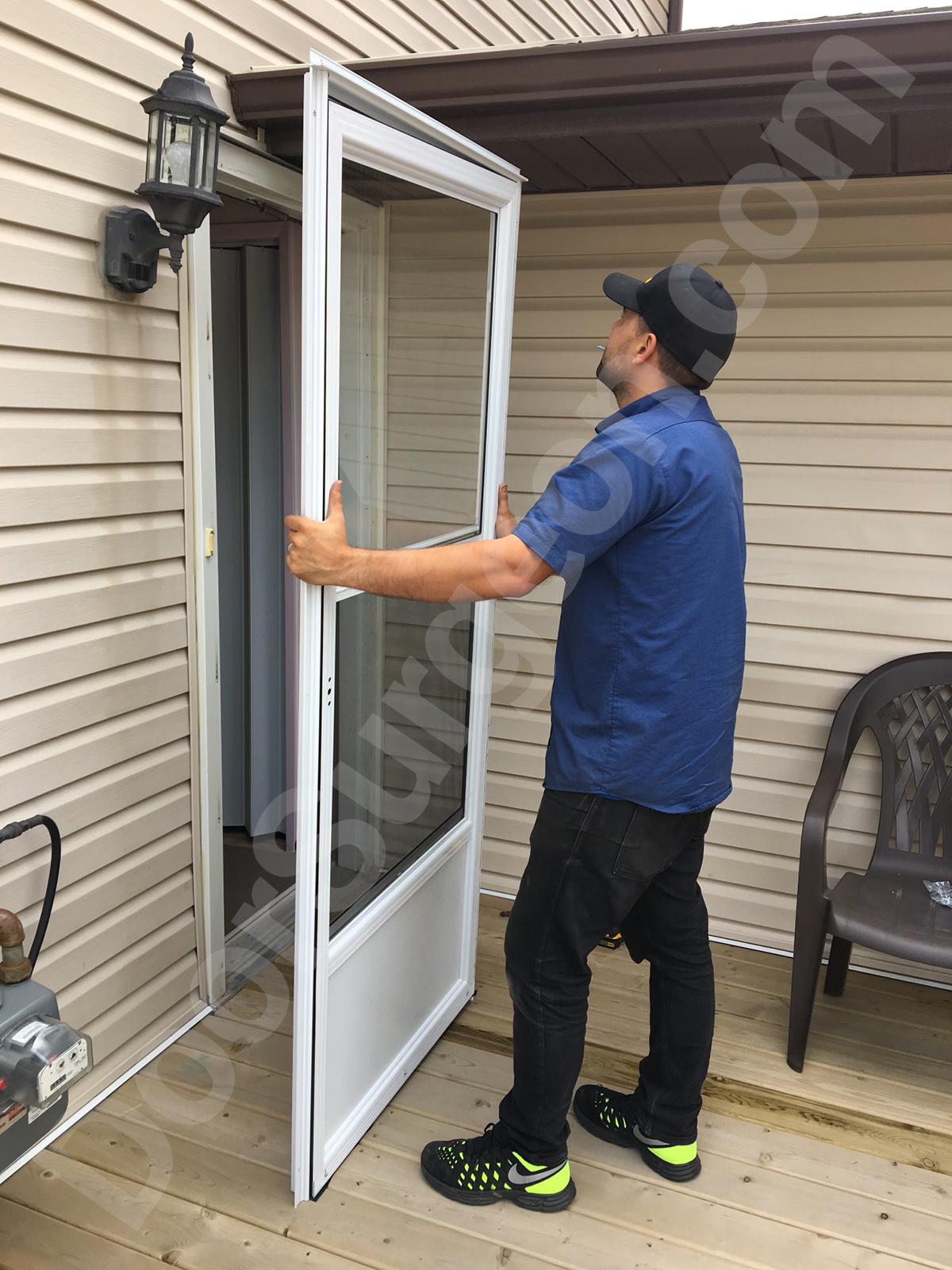 Door Surgeon new storm and screen door installation technician installs a new storm door