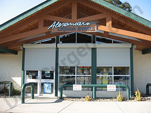 Roll shutter security rolls half extended on storefront door and windows.