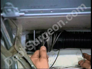 Door Surgeon truck rolling door technician repairing rolling door cable Edmonton South.