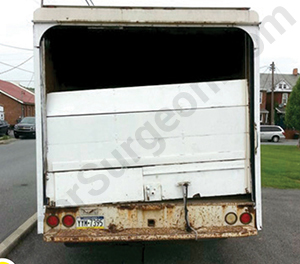 broken rolling door on back of truck.